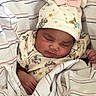 baby, sleeping, infant, blanket, hat, clothing, cute, newborn, child, soft, cozy, striped, pattern, person, wrapped, peaceful, mickey_mouse, pink_bow, resting, adorable