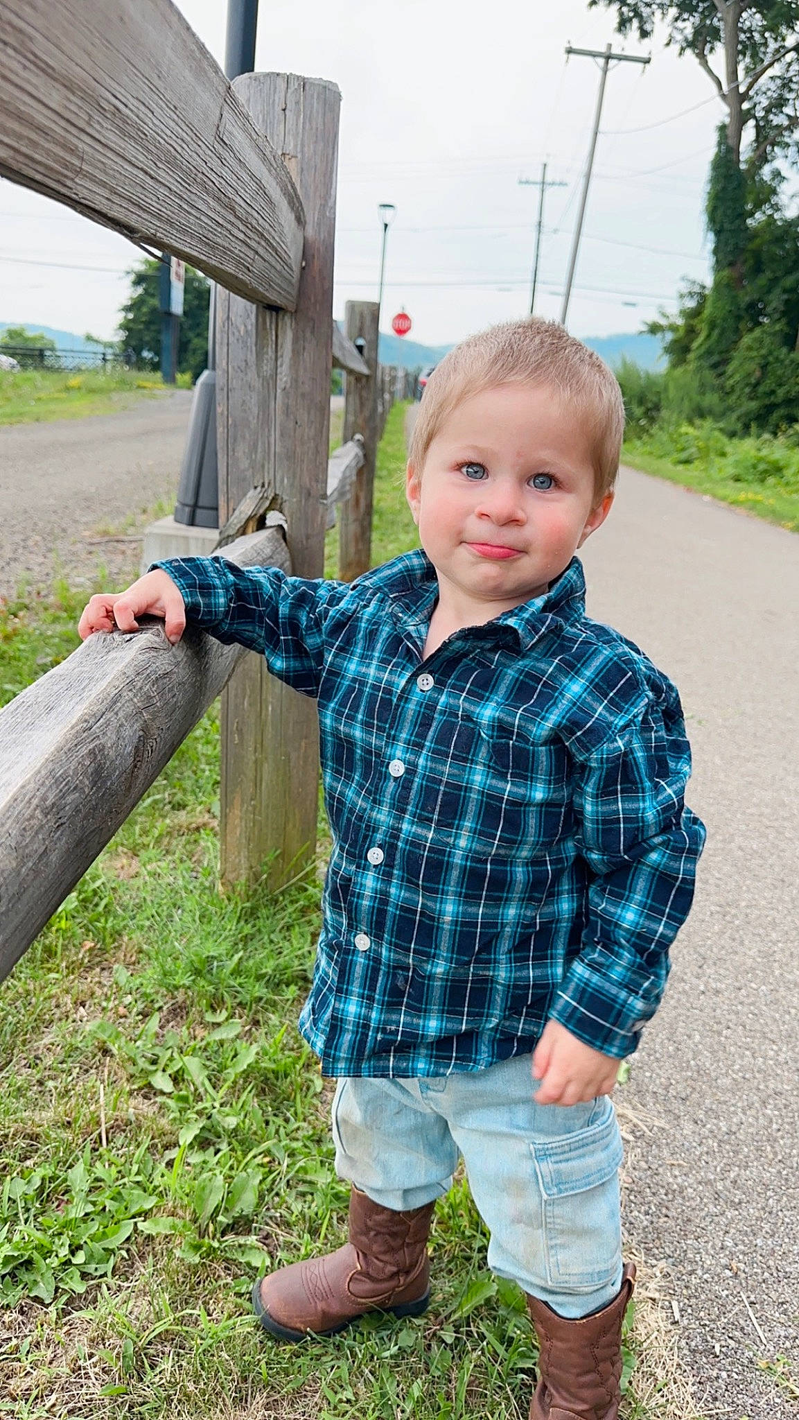 Hunter is registered to the contest to win money with this photo: fun, grass, grass_family, hairstyle, happy, joy, leisure, people_in_nature, person, plaid, plant, public_space, sky, sleeve, smile, standing, summer, t_shirt, tartan, toddler