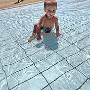 Enzo a rejoint le concours — aidez-le/la à gagner de superbes lots ! adult, baby, babycrawling, bathing, clothing, crawling, face, head, male, man, person, photography, pool, portrait, shorts, sitting, swimmingpool, swimwear, water