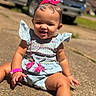 baby, child, smiling, outdoor, sunny, driveway, blue_outfit, pink_bow, bracelet, necklace, sitting, cute, happy, infant, accessories, daytime, vehicle, concrete, portrait, ruffled_sleeves