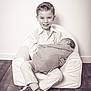child, baby, boy, newborn, smiling, sitting, armchair, clothing, floor, wooden_floor, portrait, black_and_white, monochrome, happy, indoor, people, infant, family, cute, toddler