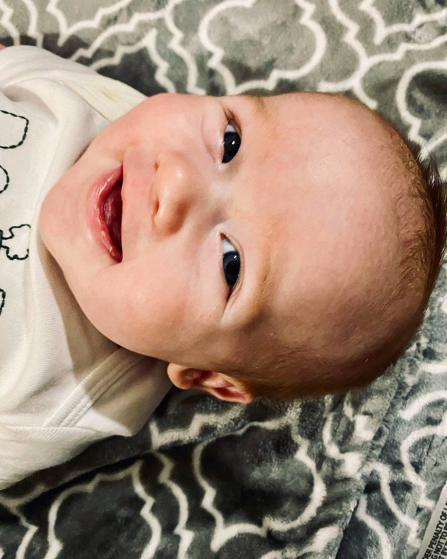 Hudson is registered to the contest to win money with this photo: baby, baby_toddler_clothing, cheek, child, chin, eye, eyebrow, eyelash, face, facial_expression, forehead, happy, head, iris, lip, nose, person, skin, sleeve, smile