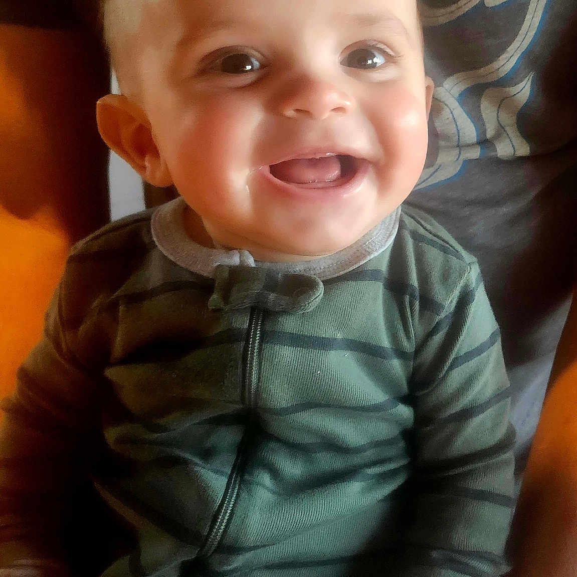 Rooke joined the competition — help win amazing prizes! baby, babylaughing, bodypart, clothing, coat, face, finger, hand, happy, head, jacket, laughing, mouth, pants, person, photography, portrait, sitting, smile, teeth