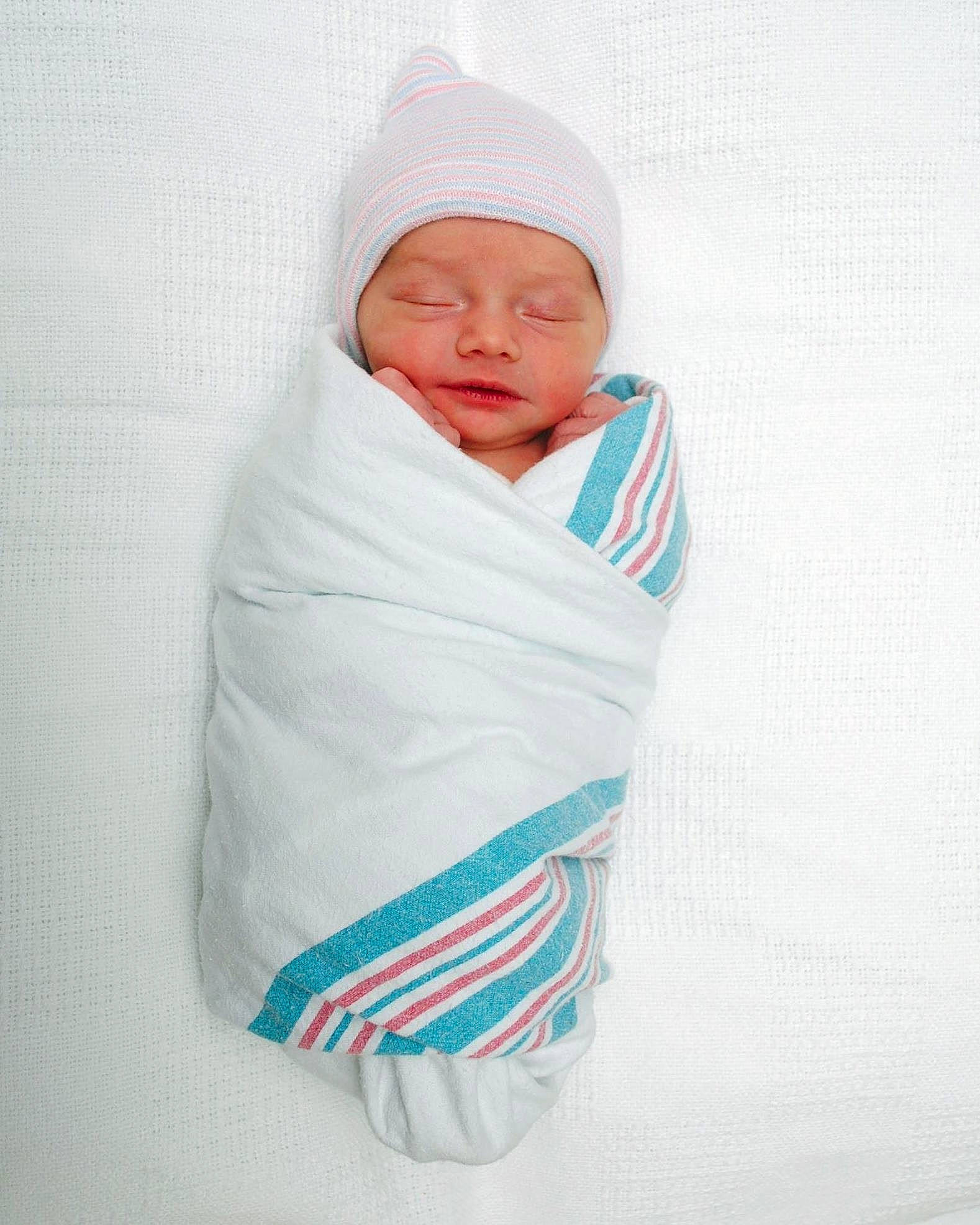 Adrienne is registered to the contest to win money with this photo: baby, baby_products, baby_sleeping, baby_toddler_clothing, beanie, cap, child, comfort, electric_blue, face, headgear, headwear, knit_cap, linens, magenta, outerwear, person, room, sleeve, toddler