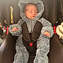 baby, infant, sleeping, car_seat, fluffy_suit, onesie, hood, child, straps, safety_harness, cute, peaceful, soft_texture, indoor, portrait, newborn, cozy, hands, face, head