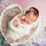 Chloe joined the competition — help win amazing prizes! newborn, baby, sleeping, wrapped, blanket, heart_shaped_bowl, headband, floral_background, soft_texture, pastel_colors, portrait, cute, peaceful, infant, fuzzy_blanket, resting, pink, white, flower, cozy