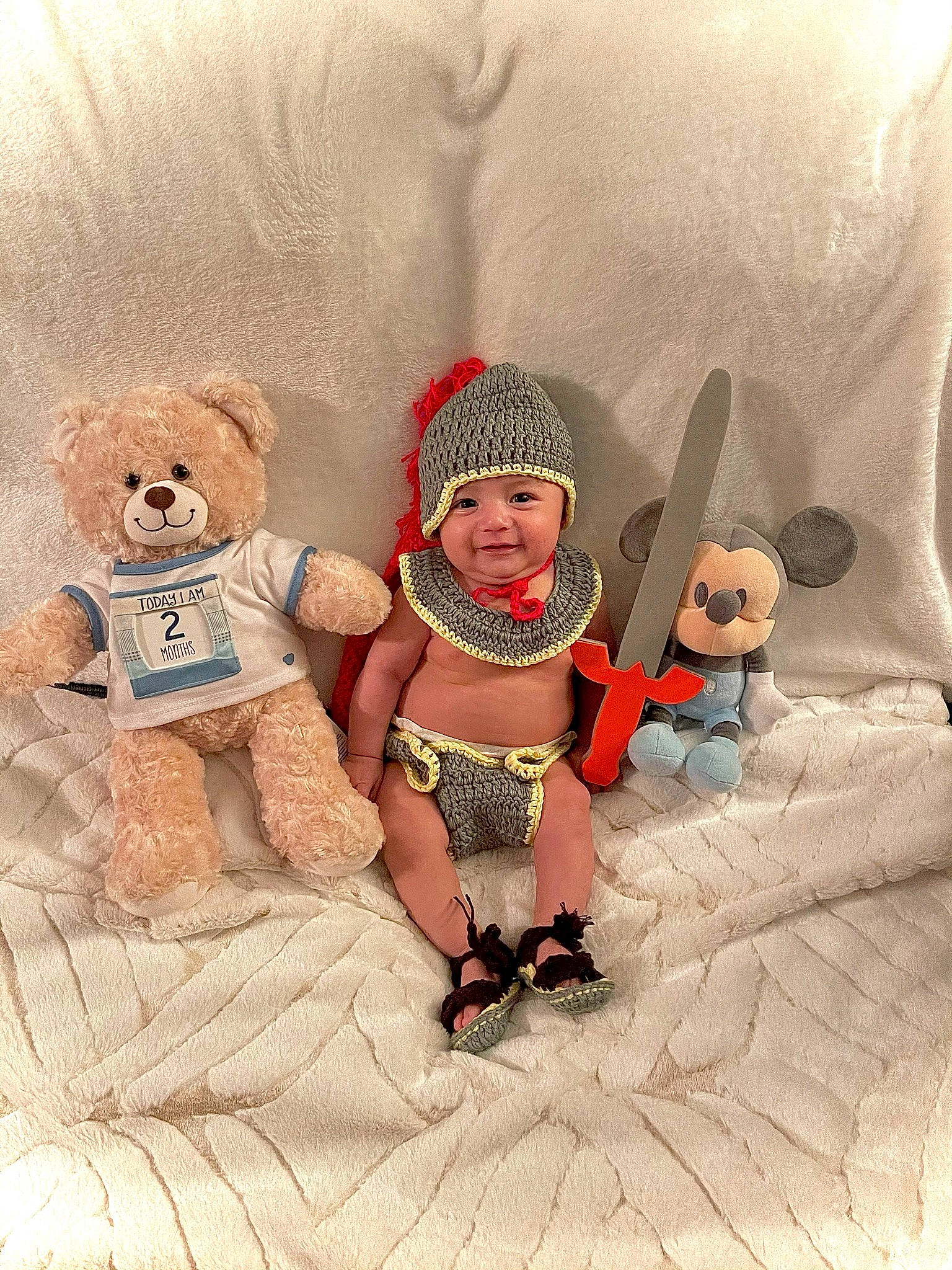 Gael is registered to the contest to win money with this photo: art, baby, baby_sleeping, baby_toddler_clothing, child, comfort, costume_hat, fashion_accessory, fictional_character, fun, happy, head, headwear, joy, person, plush, sitting, stuffed_toy, teddy_bear, thigh