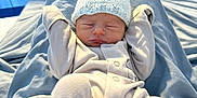 River-Lee is registered to the contest to win money with this photo: baby, bed, blanket, blue, child, cozy, cute, hat, hospital_bed, indoors, infant, knitted_hat, newborn, onesie, peaceful, person, portrait, resting, sleeping, soft_fabric