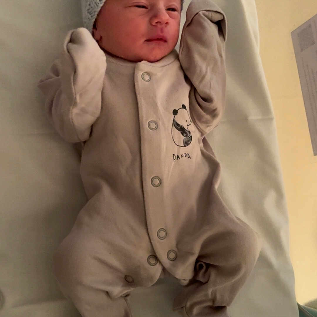 River-Lee is registered to the contest to win money with this photo: baby, bed, blanket, clothing, cute, hat, human, indoors, infant, lying_down, newborn, newborn_baby, onesie, panda, person, portrait, resting, sleepwear, small, soft