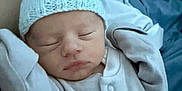 River-Lee is registered to the contest to win money with this photo: newborn, baby, sleeping, hat, knitted_hat, blanket, clothing, infant, cute, peaceful, portrait, indoors, bed, cozy, soft, warm, resting, baby_clothes, human, child