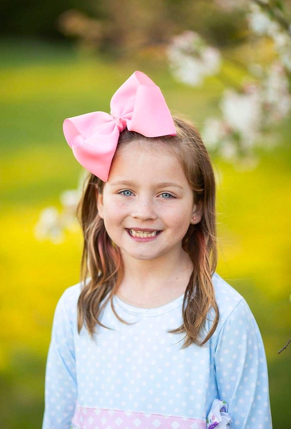 Addilyn is registered to the contest to win money with this photo: blond, brown_hair, child, flash_photography, flower, fun, grass, happy, headband, headpiece, joy, leisure, lip, long_hair, people_in_nature, person, petal, pink, plant, recreation
