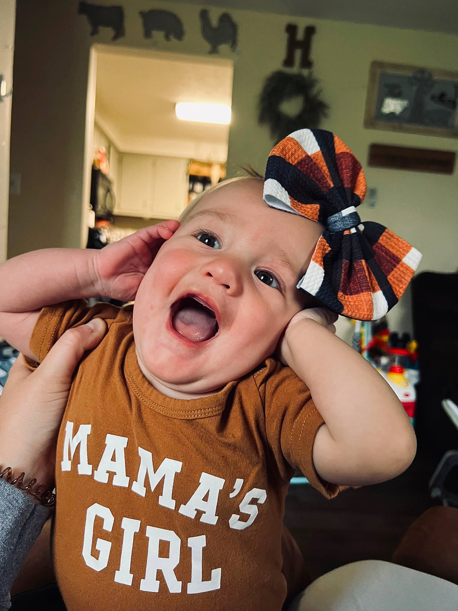 Dixie is registered to the contest to win money with this photo: baby, baby_toddler_clothing, chair, cheek, comfort, cool, eyebrow, finger, fun, gesture, happy, headwear, mouth, nose, orange, person, shout, sleeve, smile, t_shirt
