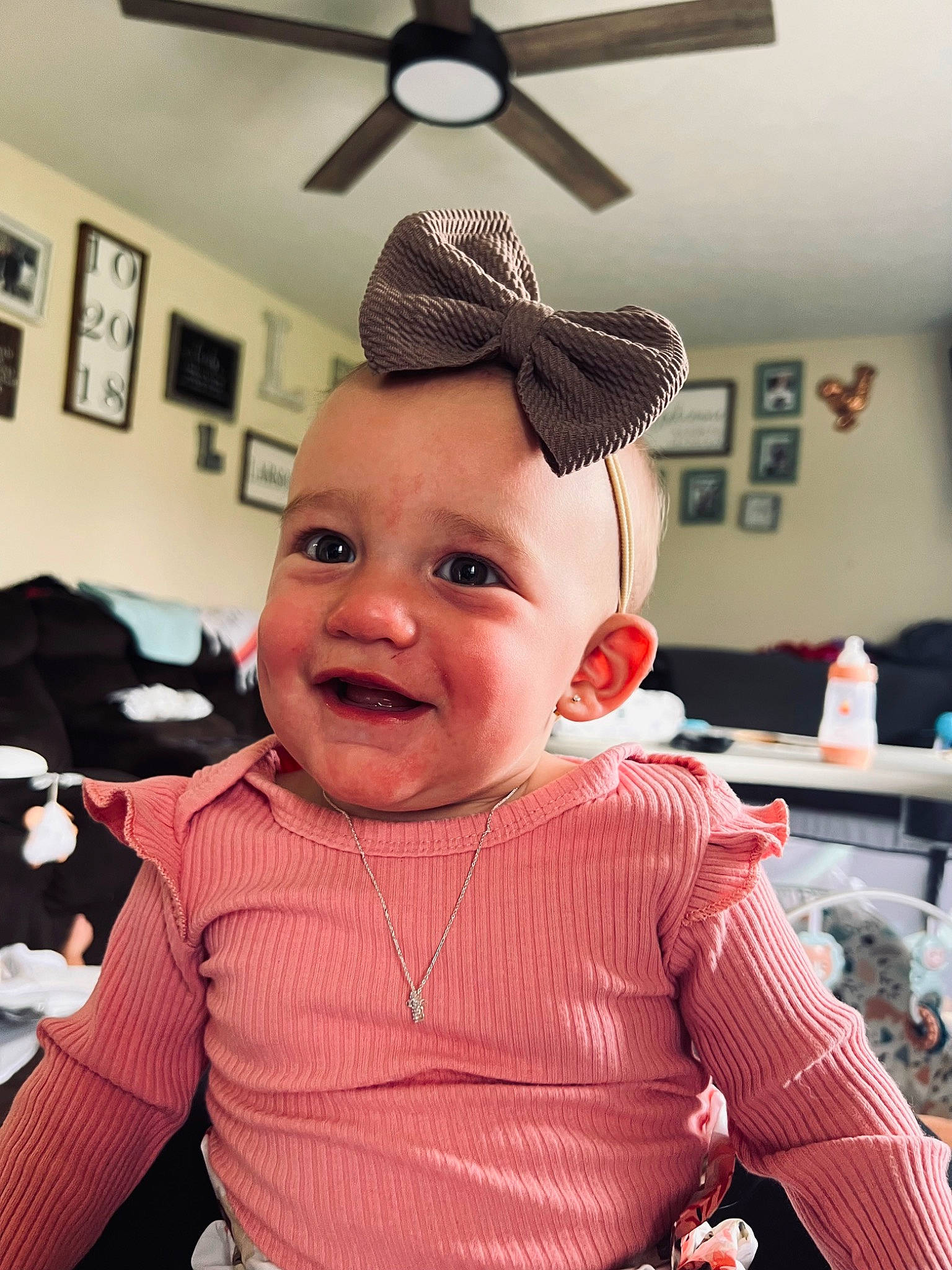 Dixie is registered to the contest to win money with this photo: baby, baby_toddler_clothing, ceiling_fan, cheek, child, costume_hat, design, fashion_accessory, fun, happy, headgear, home_appliance, joy, mechanical_fan, person, picture_frame, pink, propeller, sleeve, smile