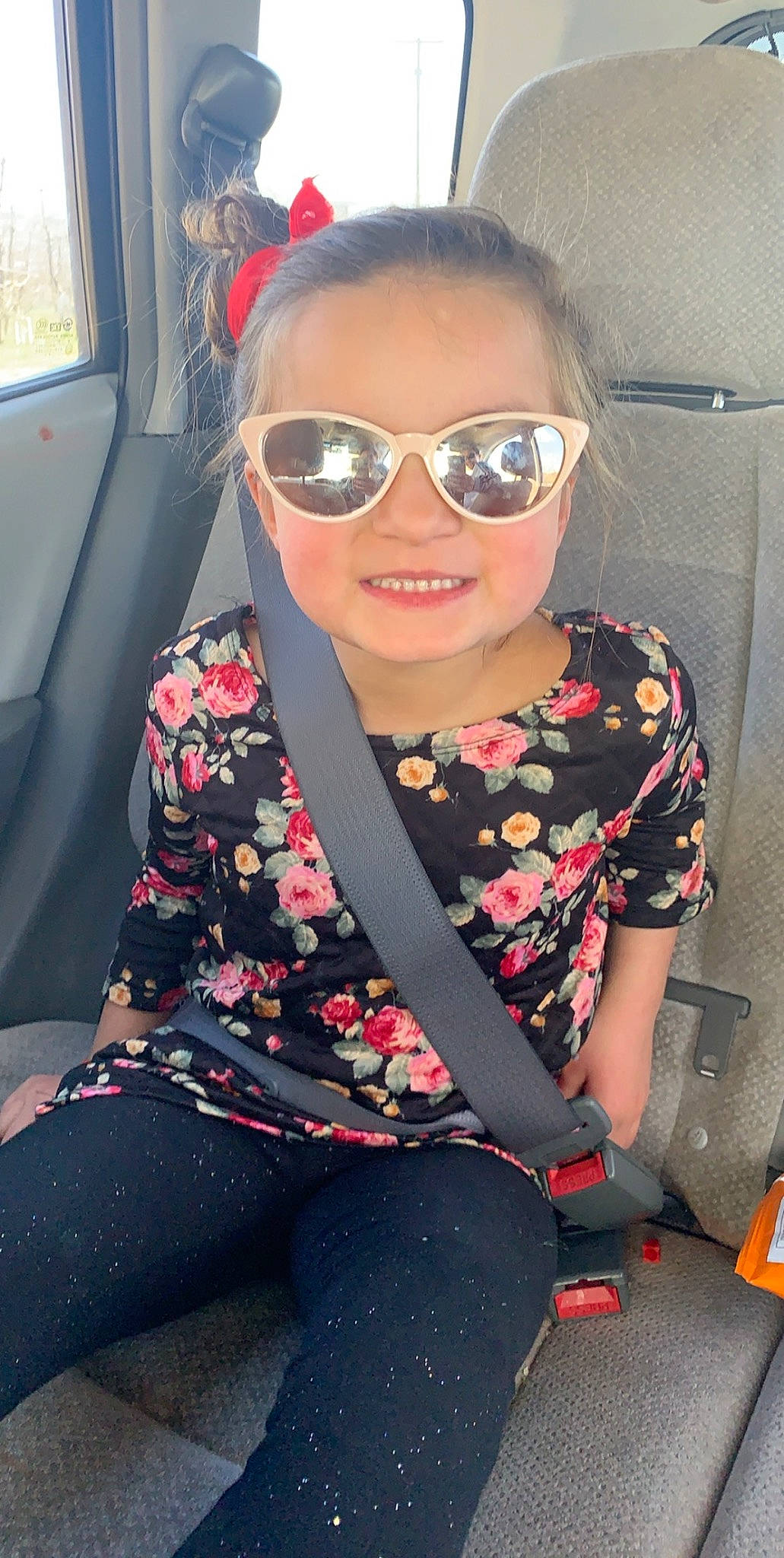 Hananiah is registered to the contest to win money with this photo: automotive_design, car_seat, clothing, cool, dress, eyewear, face, glasses, goggles, hairstyle, joy, lip, magenta, person, personal_protective_equipment, pink, smile, sunglasses, thigh, toddler