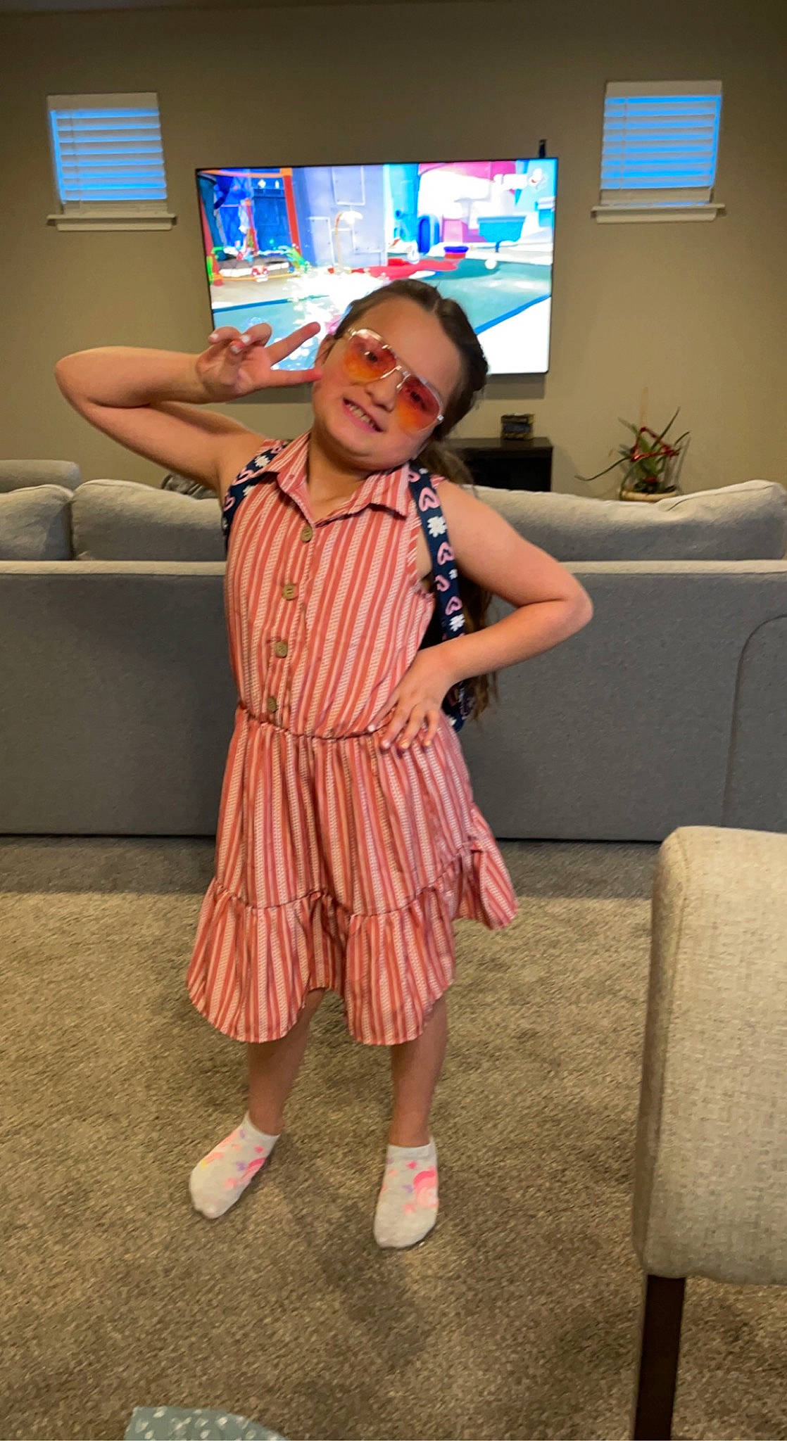 Hananiah is registered to the contest to win money with this photo: child, comfort, couch, display_device, event, flooring, fun, happy, houseplant, joy, led_backlit_lcd_display, leisure, living_room, person, picture_frame, plant, room, smile, television, television_set