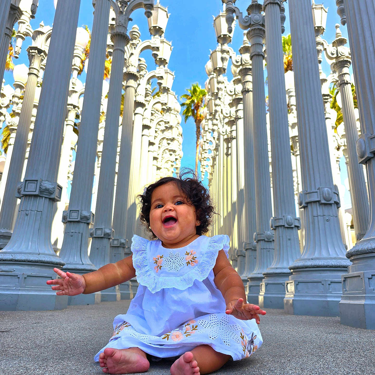 Alana Lozano joined the competition — help win amazing prizes! architecture, baby, bodypart, city, clothing, dress, face, finger, hand, happy, head, outdoors, person, photography, pillar, portrait, road, sitting, street, urban