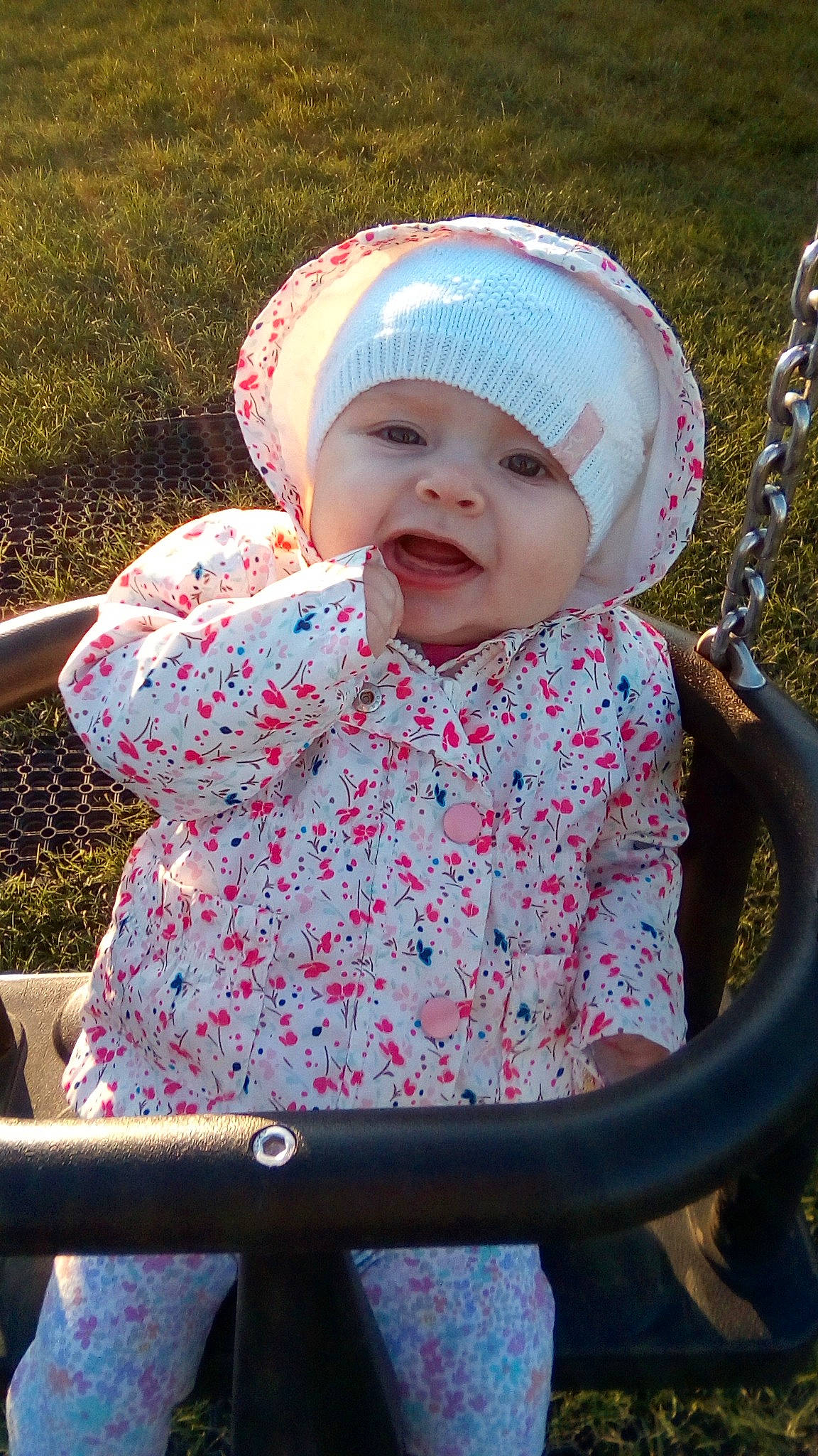 Autumn-lily is registered to the contest to win money with this photo: baby, baby_products, baby_toddler_clothing, bonnet, child, grass, headgear, headwear, person, pink, product, skin, smile, toddler