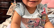 Aahmiyahlovely is registered to the contest to win money with this photo: baby, child, smiling, hat, colorful, indoor, bed, bedding, pacifier, shirt, cartoon, cute, happy, person, infant, closeup, face, hand, furniture, room