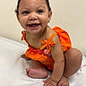 Aahmiyahlovely is registered to the contest to win money with this photo: baby, child, smile, orange_clothing, cute, happy, indoor, skin, face, toes, hands, earrings, curly_hair, sitting, posing, infant, joy, bright, playful, portrait