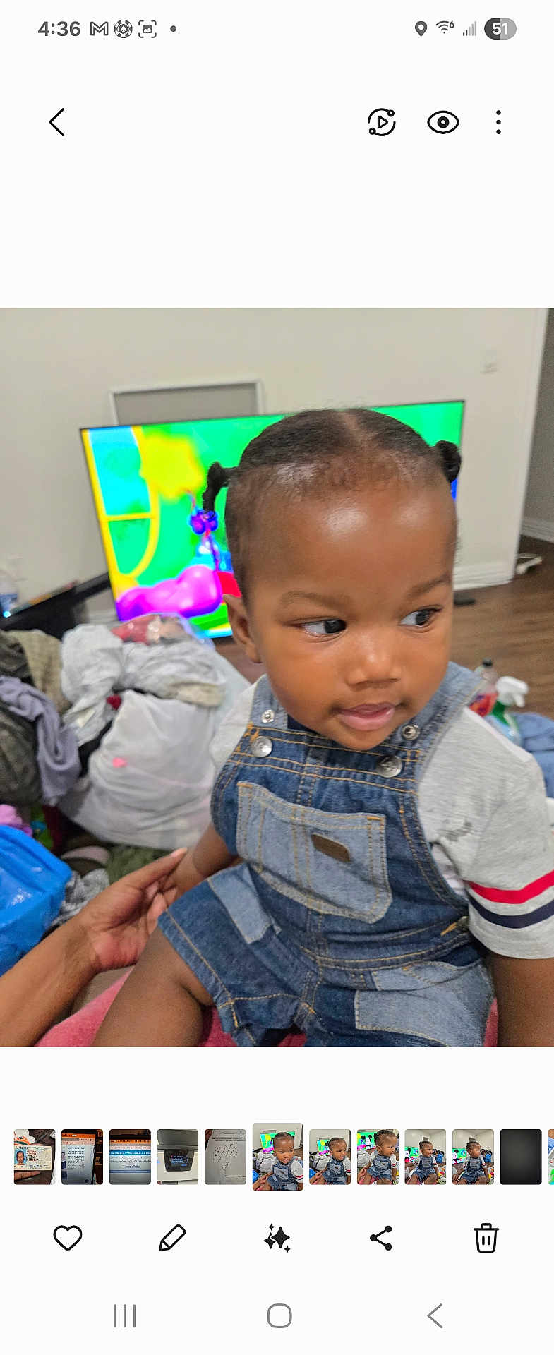 Royal joined the competition — help win amazing prizes! toddler, child, denim_overalls, indoor, television, colorful_screen, pigtails, person, clothing, hand, floor, furniture, curious, skin, hair, holding, seated, background, room, casual