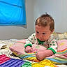 Jordan Jr is registered to the contest to win money with this photo: baby, infant, child, pillow, rainbow, pop_it_toy, toy, bed, blanket, onesie, clothing, indoor, face, hands, curtain, window, colorful, play, focused, cute