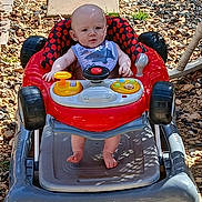 Jay joined the competition — help win amazing prizes! baby, baby_walker, bib, child, clothing, cute, expression, face, foot, gray, outdoor, person, play, red, rocks, seat, stepping_stones, summer, sunlight, toys