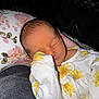 newborn, baby, sleeping, infant, onesie, floral_pattern, pillow, cozy, closeup, peaceful, cute, child, indoors, portrait, soft_lighting, resting, small, human, face, hand