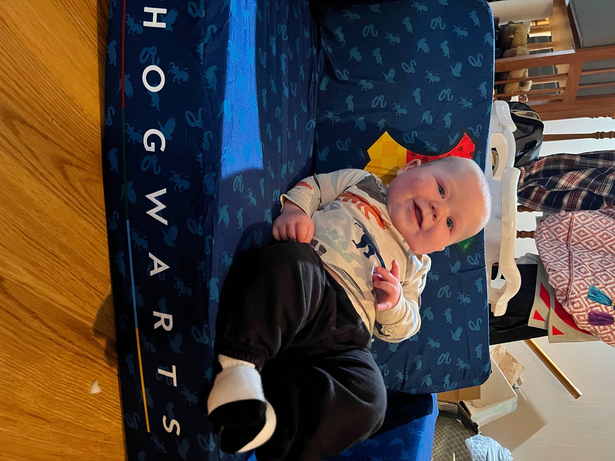 Asher is registered to the contest to win money with this photo: baby, baby_products, child, cool, fun, hardwood, hat, leisure, pattern, person, room, sitting, toddler, vacation, wood