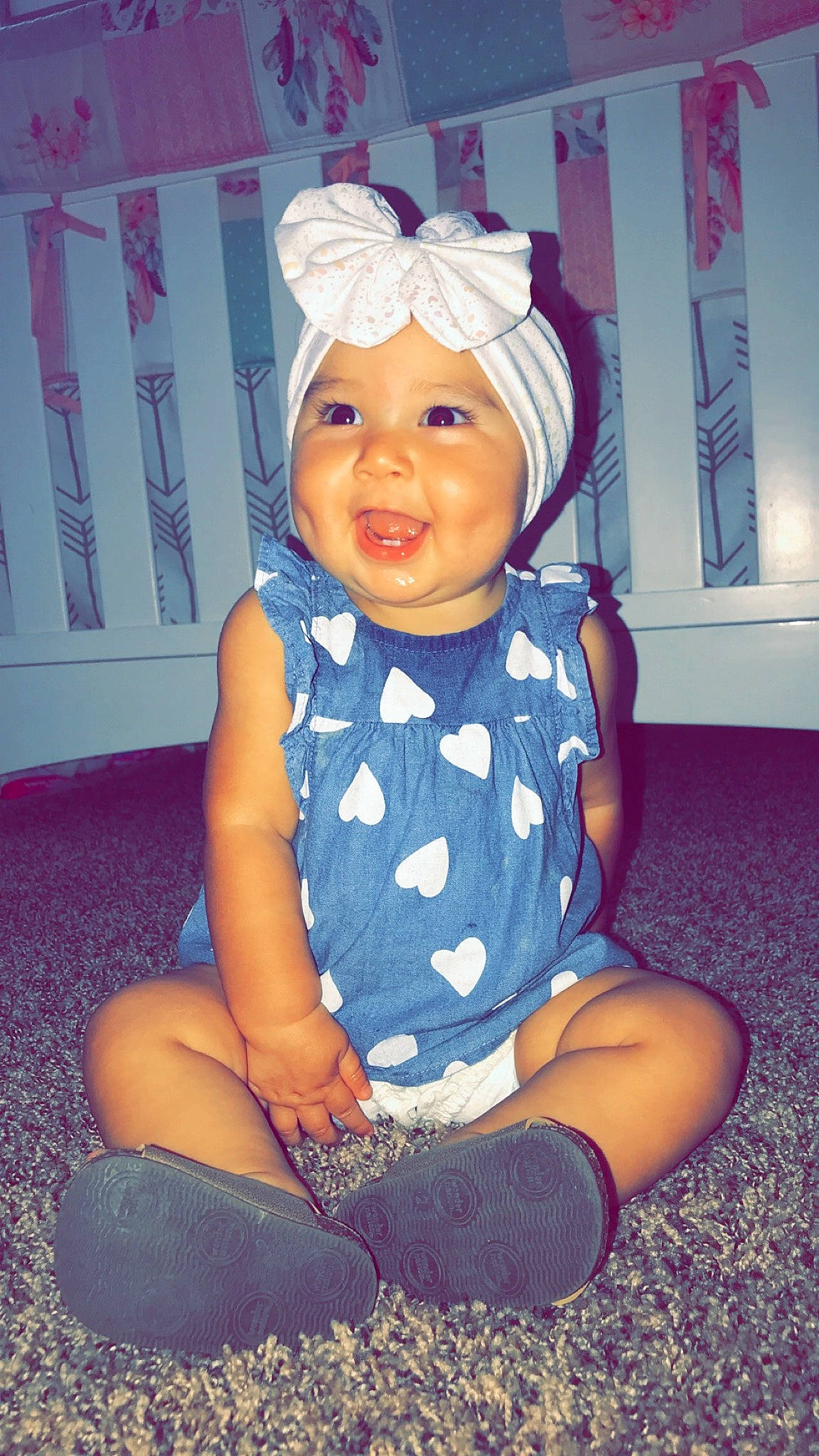 Keilani is registered to the contest to win money with this photo: baby, baby_toddler_clothing, blond, cheek, child, ear, fun, head, headgear, headwear, person, pink, purple, sitting, smile, toddler
