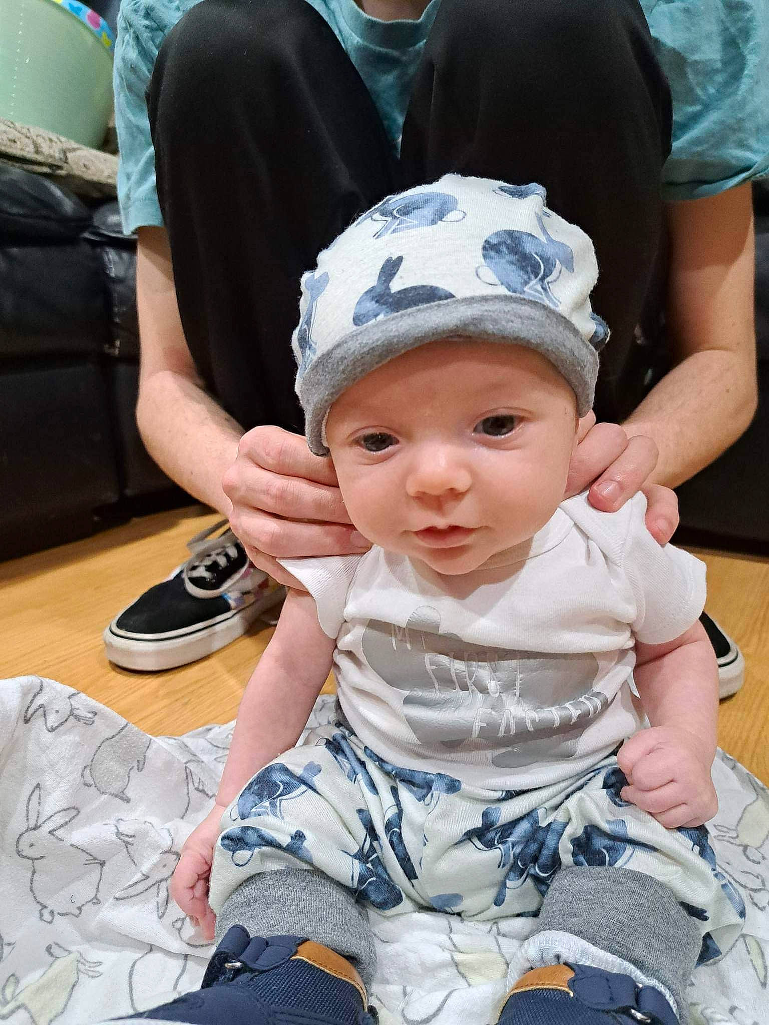 John is registered to the contest to win money with this photo: baby, baby_toddler_clothing, bag, baseball_cap, cap, chair, child, event, fun, grass, happy, hat, headwear, leisure, luggage_and_bags, person, recreation, sitting, t_shirt, toddler