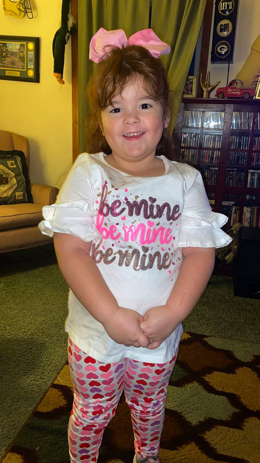 Kimberlee is registered to the contest to win money with this photo: brown_hair, child, cool, eye, facial_expression, fun, hair, happy, iris, joy, long_hair, magenta, person, picture_frame, pink, shelf, shoulder, sleeve, smile, t_shirt