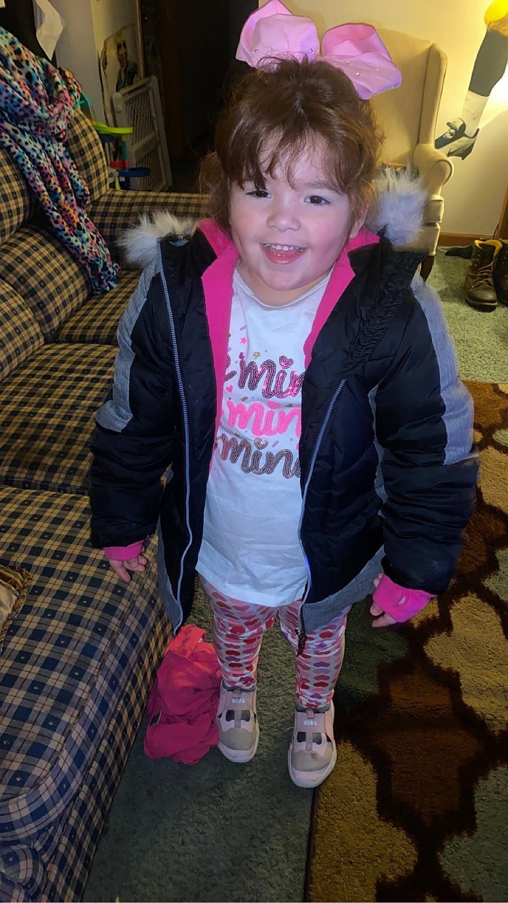 Kimberlee is registered to the contest to win money with this photo: baby_toddler_clothing, bangs, child, costume, event, fun, fur, holiday, hoodie, joy, magenta, pattern, person, pink, sleeve, smile, sock, toddler, tree, vacation