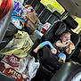 black_leather_seats, bottle, car_interior, car_seat, casual, child, dr_pepper, drink, foot, grocery_bags, hair, partial_face, person, plastic_bags, red_hair, road_trip, seatbelt, snacks, toddler, window