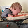 Drake is registered to the contest to win money with this photo: baby, highchair, food, messy, sleeping, child, pajamas, indoor, face_down, feeding, small_child, toddler, furniture, table, hand, cute, curly_hair, infant, resting, nap