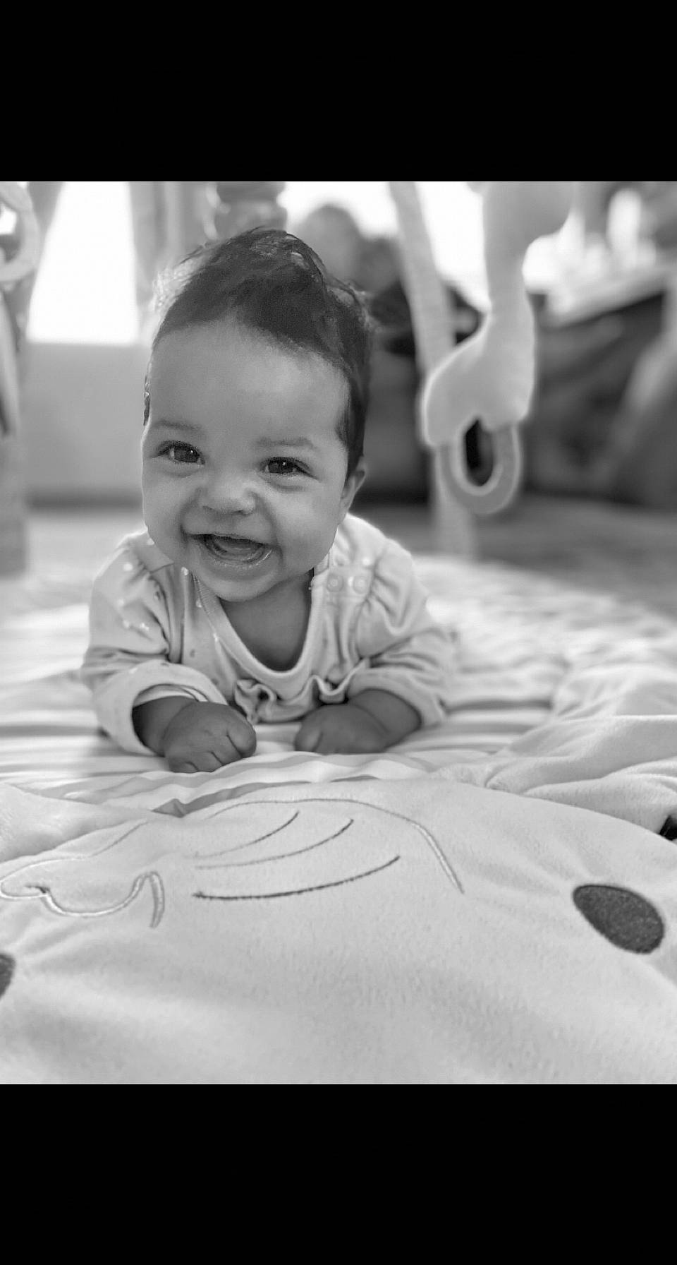 Olivia is registered to the contest to win money with this photo: baby, black, black_and_white, cheek, chin, comfort, eye, eyebrow, flash_photography, flooring, hair, happy, iris, joy, mouth, nose, person, skin, smile, style