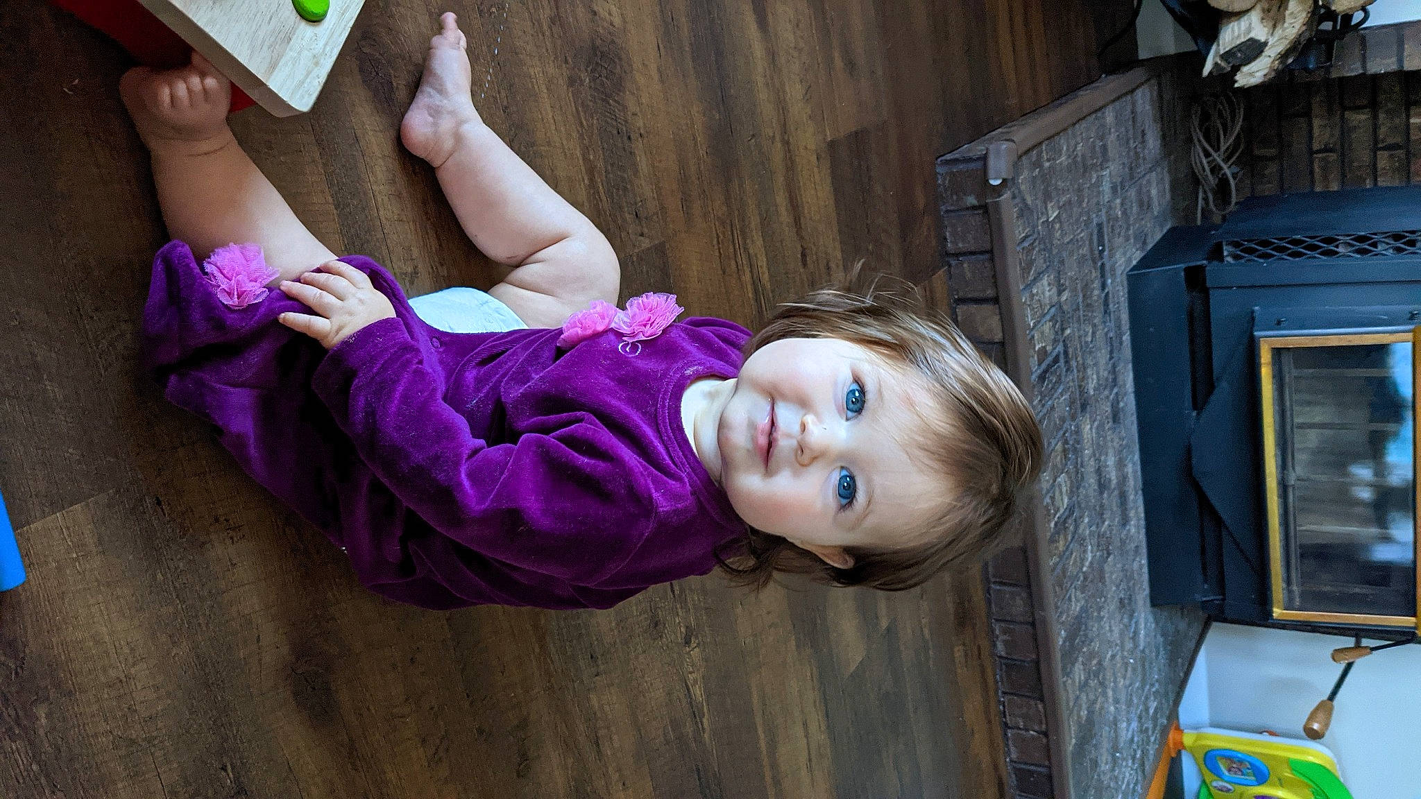 Emmaline joined the competition — help win amazing prizes! black_hair, child, floor, flooring, fun, green, hair, hairstyle, happy, hardwood, leisure, long_hair, magenta, person, pink, purple, skin, smile, thigh, toddler