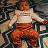 Oakley Wheeler joined the competition — help win amazing prizes! baby, infant, child, lying_down, portrait, face, headband, bow, clothing, floral_pattern, outfit, blanket, bed, indoors, looking_at_camera, neutral_expression, hands, feet, geometric_pattern, photography