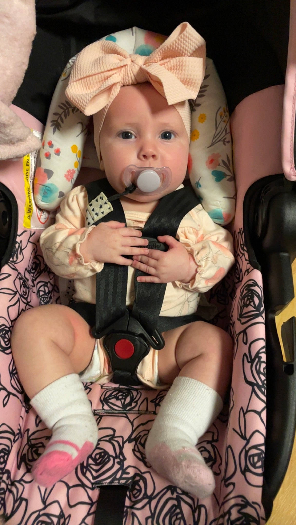 Kingsley is registered to the contest to win money with this photo: baby, baby_toddler_clothing, child, comfort, fedora, hat, head, headwear, human_leg, knee, lap, leg, nail, pattern, person, pink, sitting, skin, sock, sun_hat