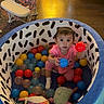 Aurora joined the competition — help win amazing prizes! toddler, ball_pit, colorful_balls, toy, soft_toy, child, indoor, living_room, wooden_floor, sofa, baby_chair, curious, playtime, pink_clothing, patterned_fabric, seated, floor, home, cute, childhood