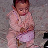 Aurora joined the competition — help win amazing prizes! toddler, child, pink_pajamas, purse, bows, hair_accessories, sitting, blanket, indoor, footwear, gold_chain, focused, cute, baby, person, small_bag, patterned_blanket, young_child, indoors, adorable