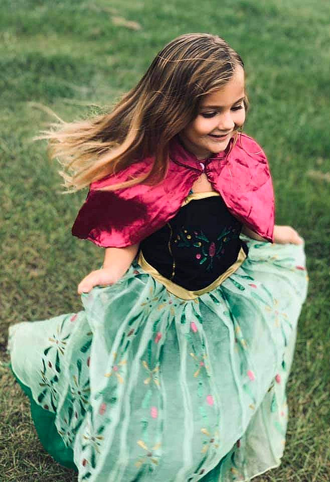 Penelope joined the competition — help win amazing prizes! baby_products, baby_toddler_clothing, brown_hair, child, child_model, clothing, costume, dress, fashion_accessory, grass, green, joy, long_hair, pattern, person, photography, pink, plant, sitting, textile