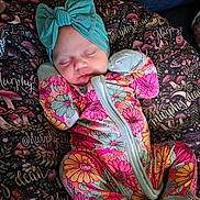 Murphy-Dean is registered to the contest to win money with this photo: baby, newborn, sleeping, infant, portrait, floral, swaddle, blanket, turquoise_bow, bow, colorful, indoors, cozy, textile, patterned_fabric, mushroom_pattern, mittens, socks, peaceful, closeup