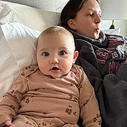 Lillian is registered to the contest to win money with this photo: baby, child, teenager, bed, pillow, blanket, hoodie, lamp, indoor, portrait, blue_eyes, cute, expression, sitting, clothing, headboard, face, mouth, skin, pajamas