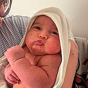 Oliver is registered to the contest to win money with this photo: arm, baby, bath_time, closeup, cute, expression, face, glasses, hand, holding, indoor, infant, love, newborn, parent, person, pout, skin, striped_shirt, towel