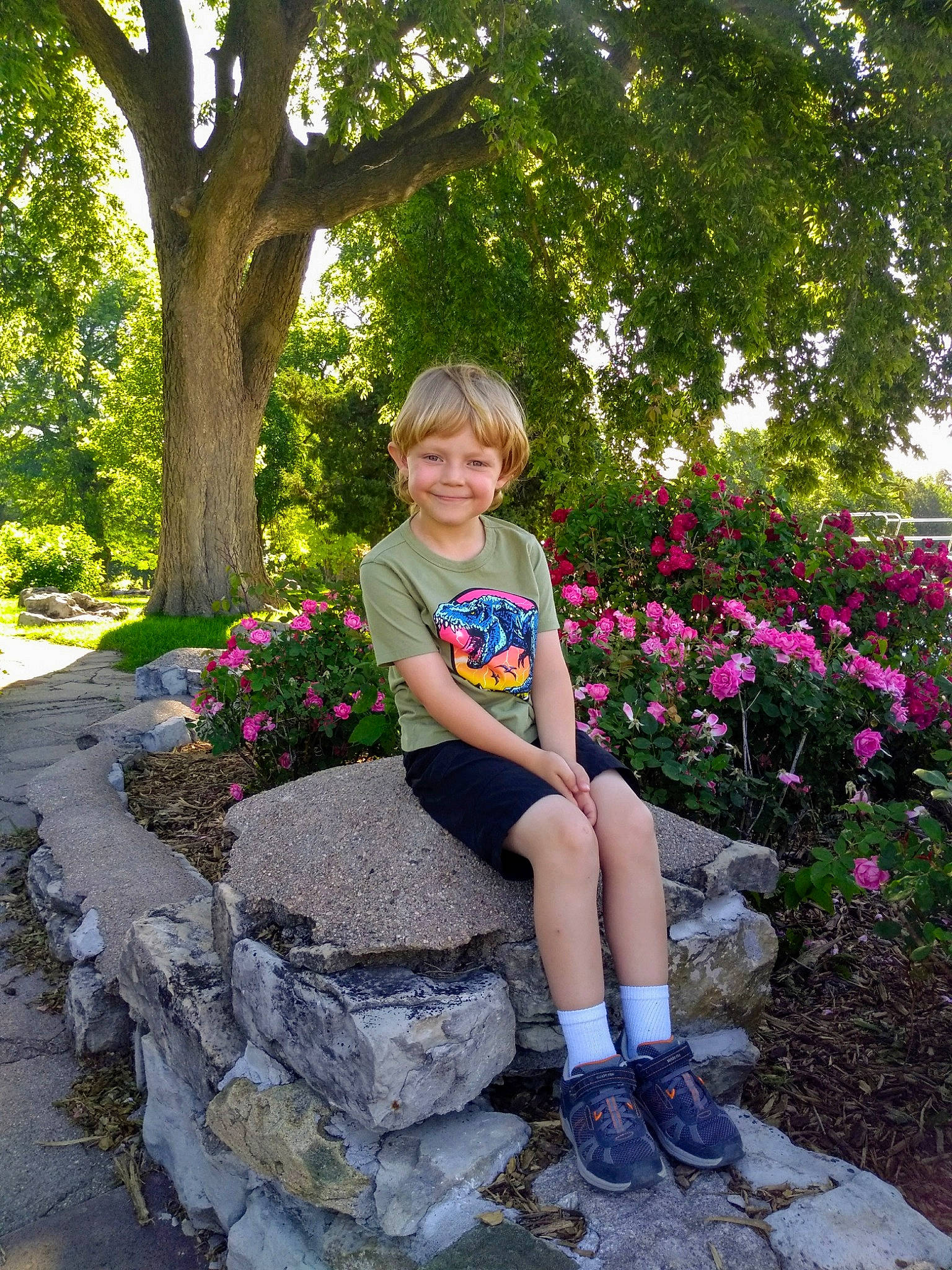 Coltin is registered to the contest to win money with this photo: blue, botany, dress, eye, flower, footwear, garden, joy, leaf, leg, leisure, park, person, photography, pink, plant, shoe, sitting, spring, summer
