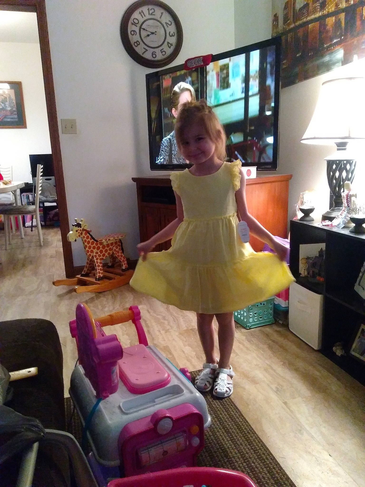 Barbara is registered to the contest to win money with this photo: child, costume, couch, dress, footwear, fun, furniture, house, interior_design, joy, leg, living_room, person, pink, room, shoe, shoulder, sitting, table, vacation