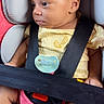 baby, car_seat, child, infant, pacifier, yellow_clothing, black_strap, red_padding, gray_padding, safety_belt, cute, side_profile, skin, legs, foot, seat, comfort, portrait, indoors, young_child