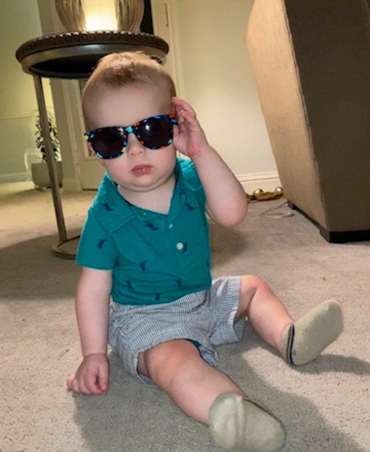 Beckham joined the competition — help win amazing prizes! baby, baby_toddler_clothing, child, eyewear, flooring, foot, glasses, goggles, human_leg, knee, leg, person, personal_protective_equipment, shorts, sitting, sleeve, sunglasses, t_shirt, thigh, toddler