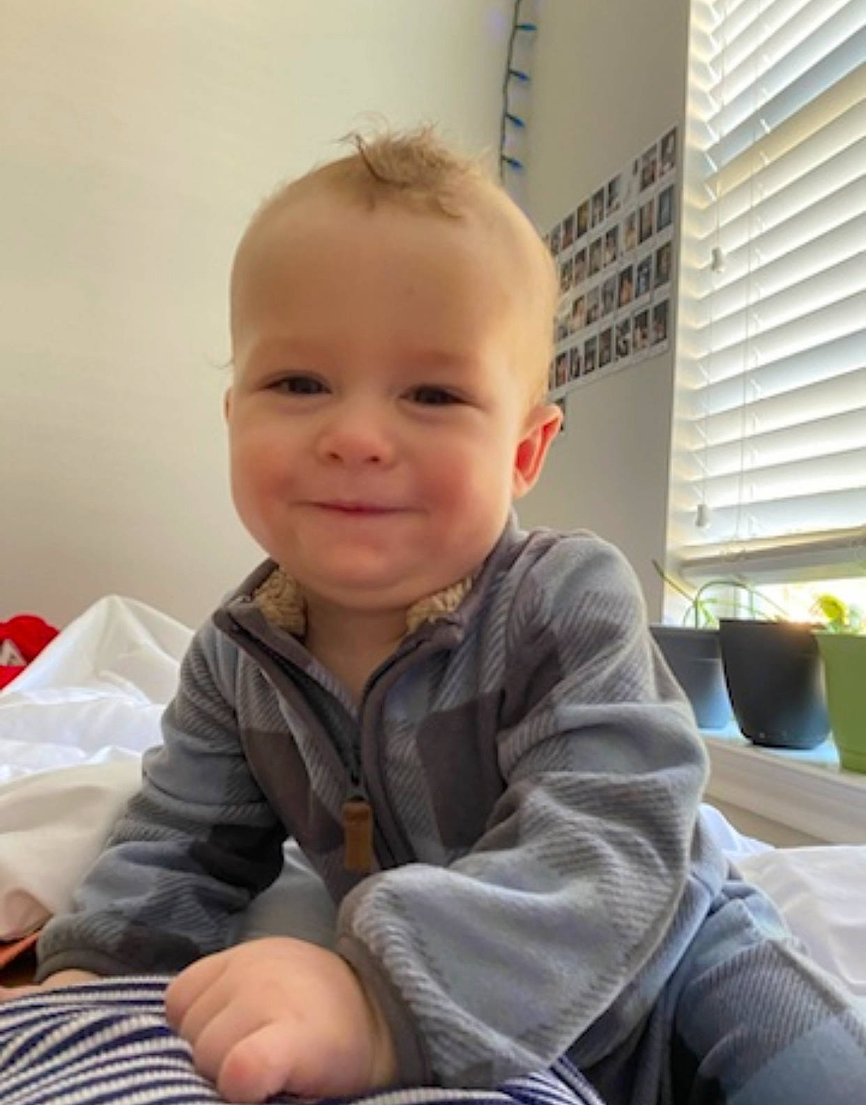 Beckham is registered to the contest to win money with this photo: baby, baby_toddler_clothing, cheek, child, chin, comfort, eye, finger, flooring, happy, head, houseplant, joy, nose, person, skin, sleeve, smile, t_shirt, toddler