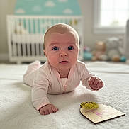 Maeve joined the competition — help win amazing prizes! baby, infant, pink_onesie, blanket, crib, nursery, stuffed_toys, milestone_card, two_months, face, wide_eyes, soft_lighting, indoor, cute, child, portrait, lying_down, white, cozy, home